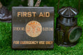 Vintage first aid kit and lantern on grass