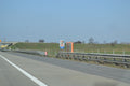 Highway with grassy embankment and signage